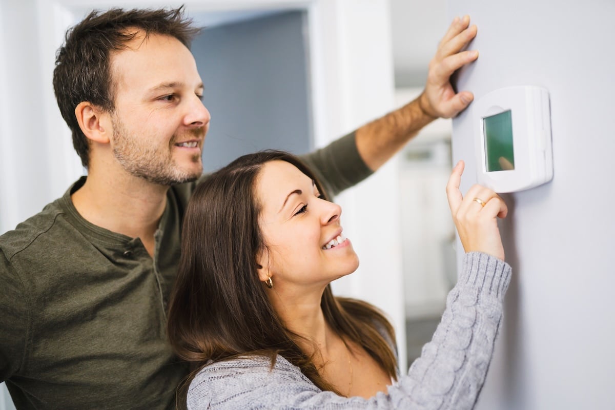 A couple set the thermostat at home