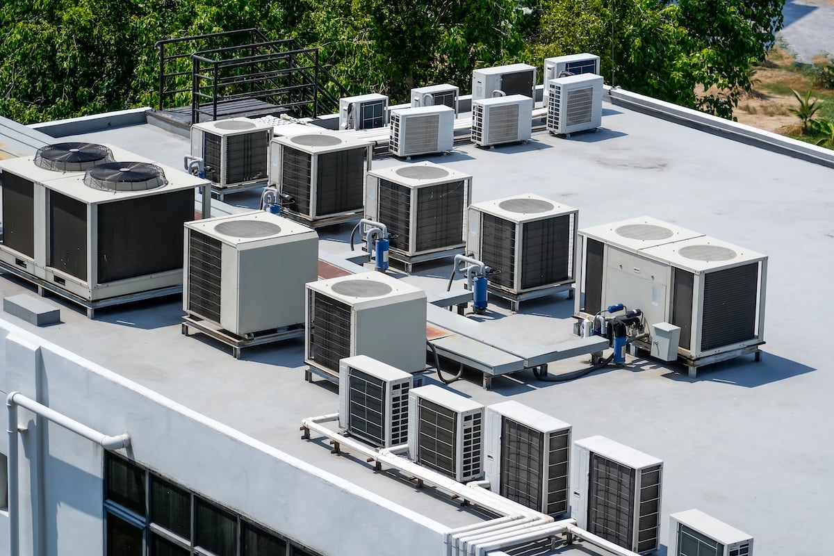 The external units of the commercial air conditioning and ventilation systems are installed on the roof of an industrial building