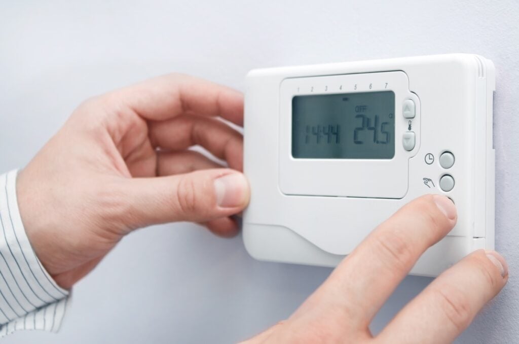 Modern furnace setting panel. Depth of field on the buttons thermostat replacement cost