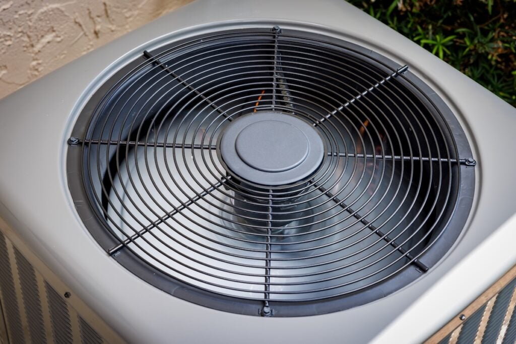 Modern residential HVAC air conditioner unit fan top view. how long do ac units last