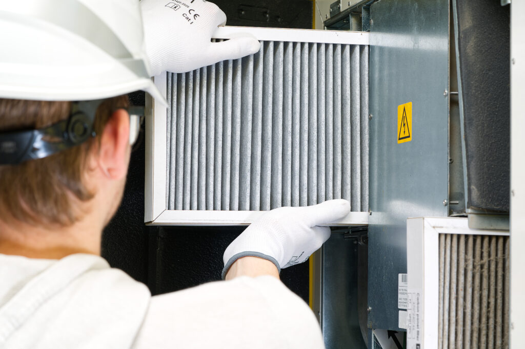 what is the $5000 rule for hvac? hvac filter replacement home central air system. servicemen changing filter in furnace. Change filter in rotary heat exchanger recuperator.