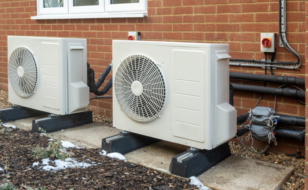 best hvac system for home Two air source heat pump units installed on a modern house