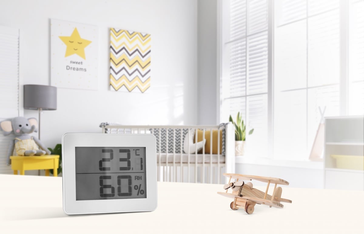 Cute baby room interior with crib and big window