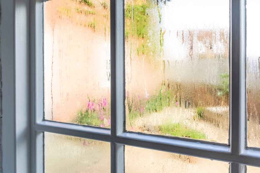 Condensation on an old window of a home how to reduce humidity in house