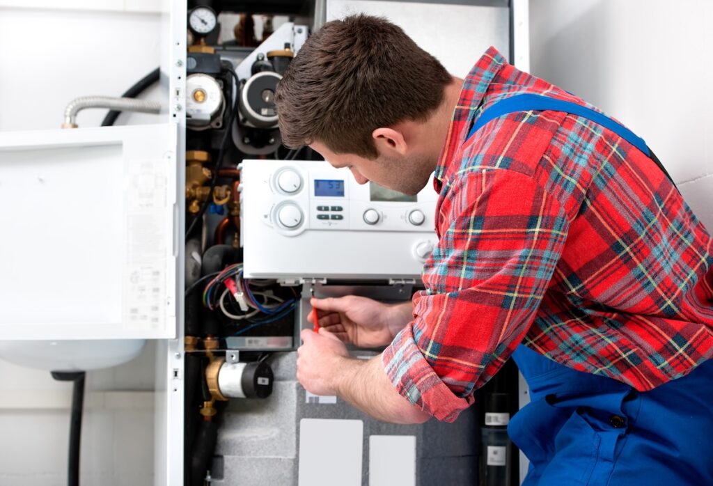 boiler replacement Technician servicing the gas boiler for hot water and heating