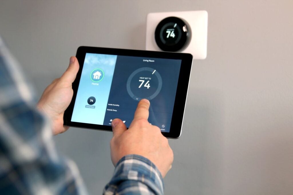 air products man holding modern thermostat 