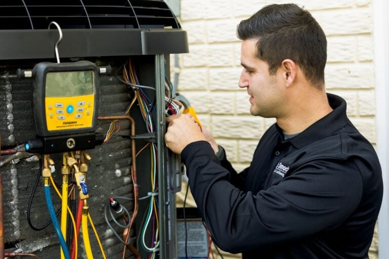 cooling maintenance Smock HVAC worker inspecting unit outside modern house