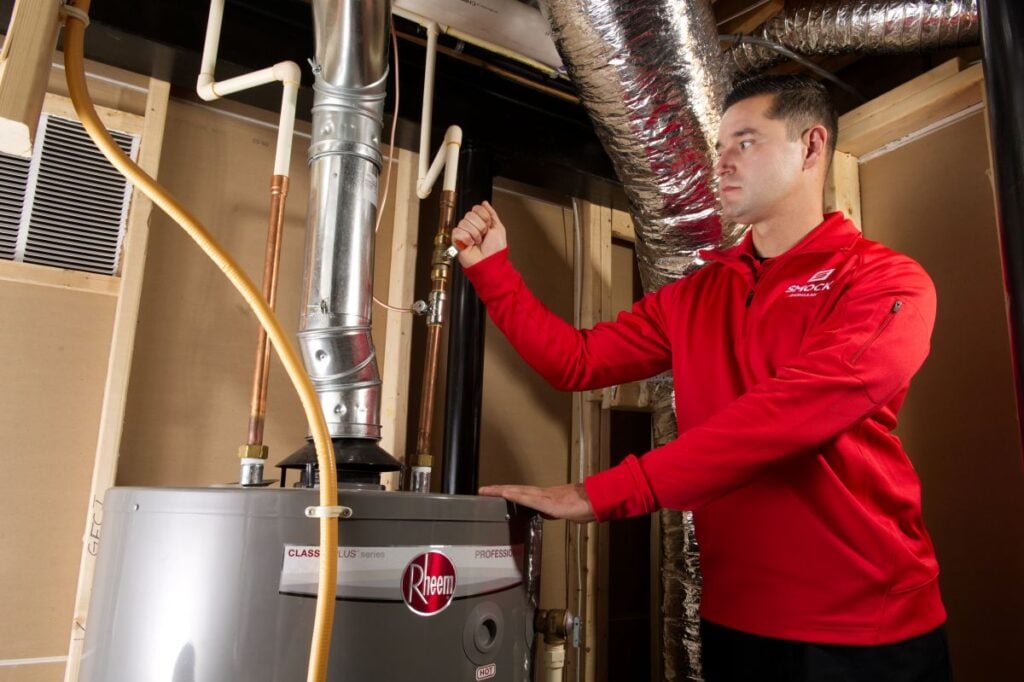 hvac financing Smock HVAC worker adjusting temperature in modern system