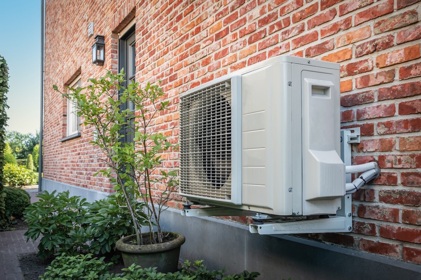 Outdoor heat pump on brick wall