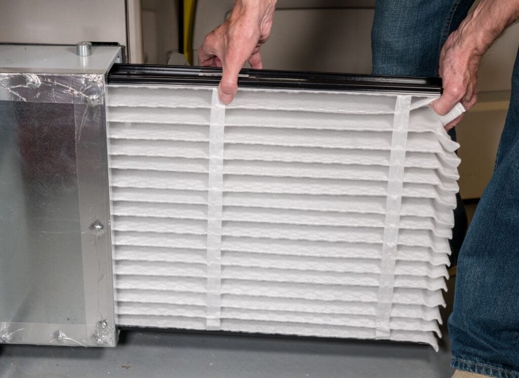 best hvac filter for allergies man replacing clean inside basement