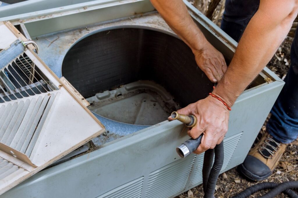 hvac troubleshooting worker fixing air conditioner outside