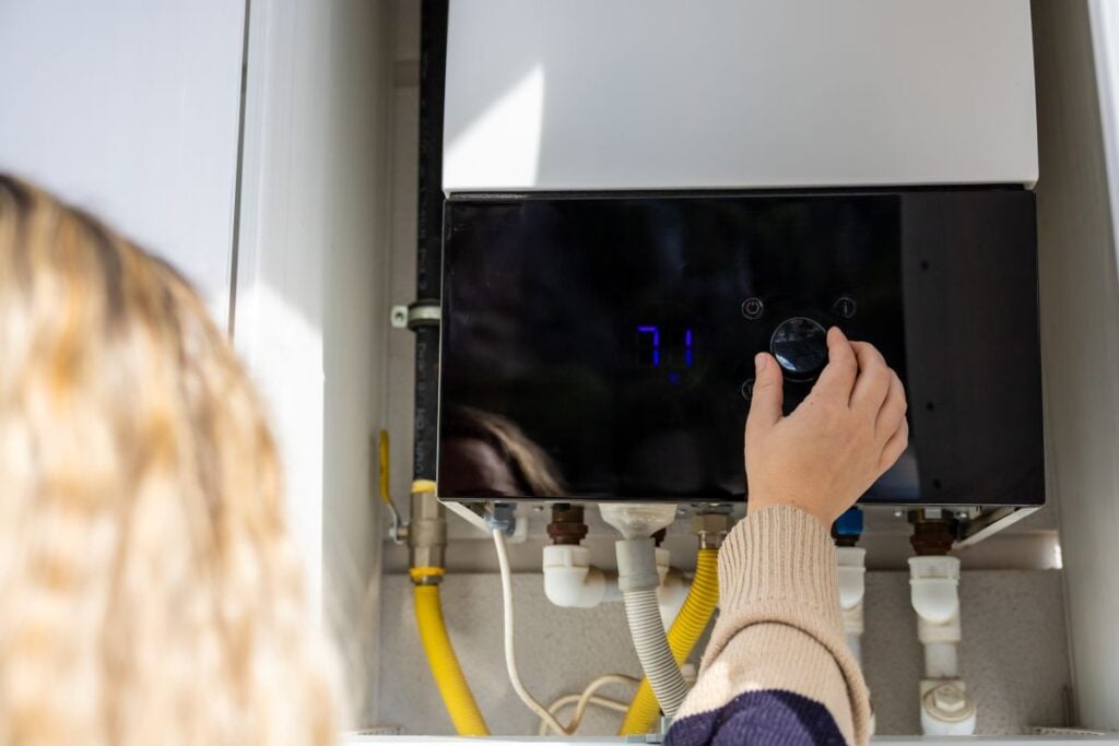 hybrid water heater modern woman adjusting temperature