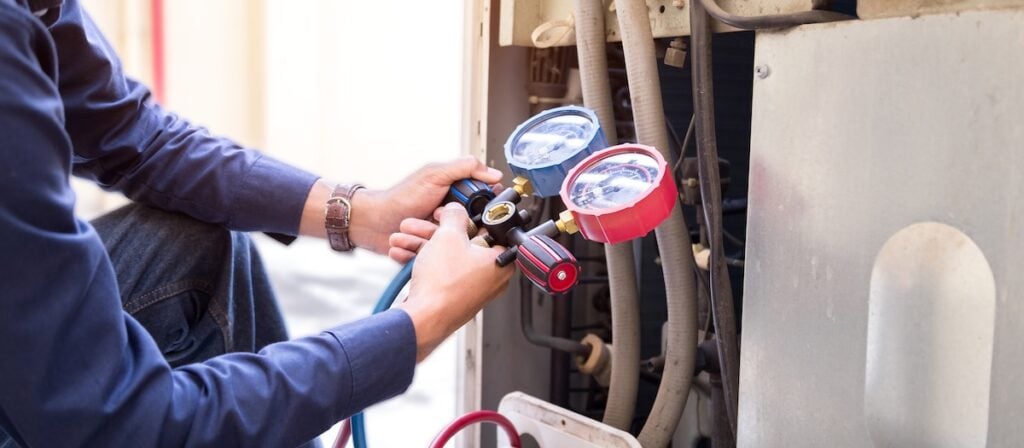 Technician is checking air conditioner ,measuring equipment for filling air conditioners.
