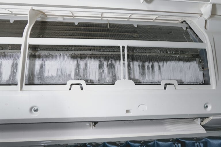 Air conditioner maintenance. Ice on air conditioner. Service air conditioner. fin of the cooling unit in the air conditioner have a lot of ice and need to repair and service
