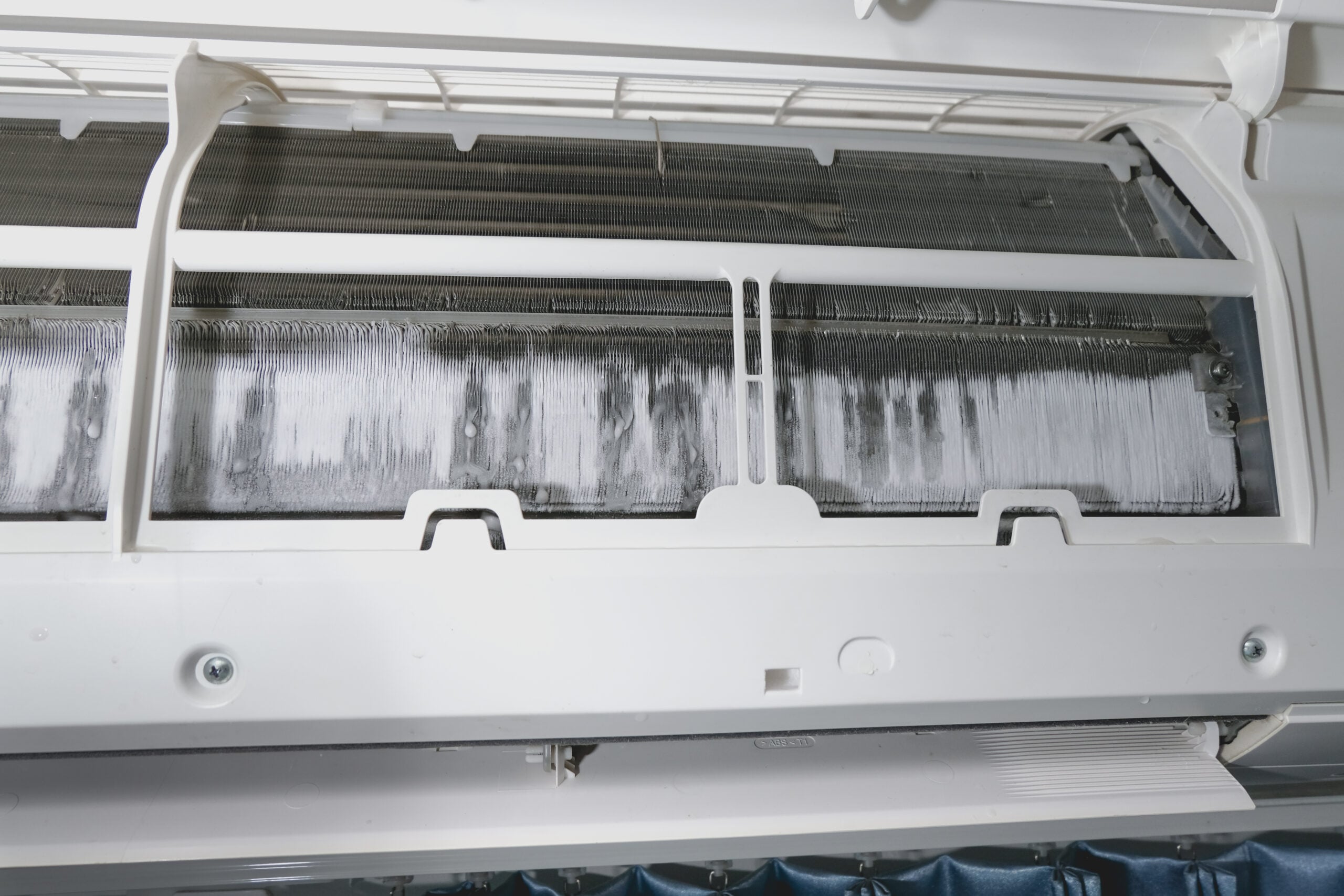 Air conditioner maintenance. Ice on air conditioner. Service air conditioner. fin of the cooling unit in the air conditioner have a lot of ice and need to repair and service