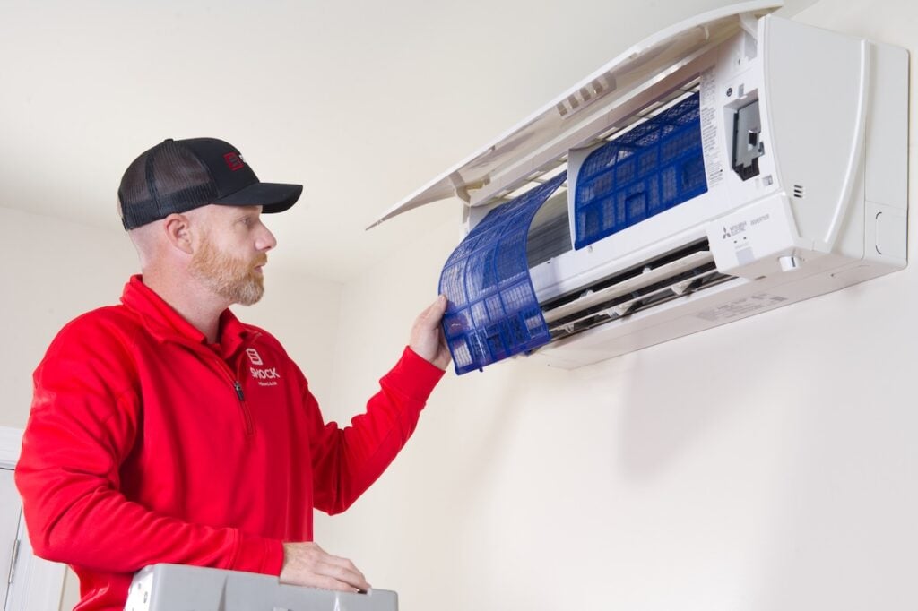 Smock worker doing hvac maintenance